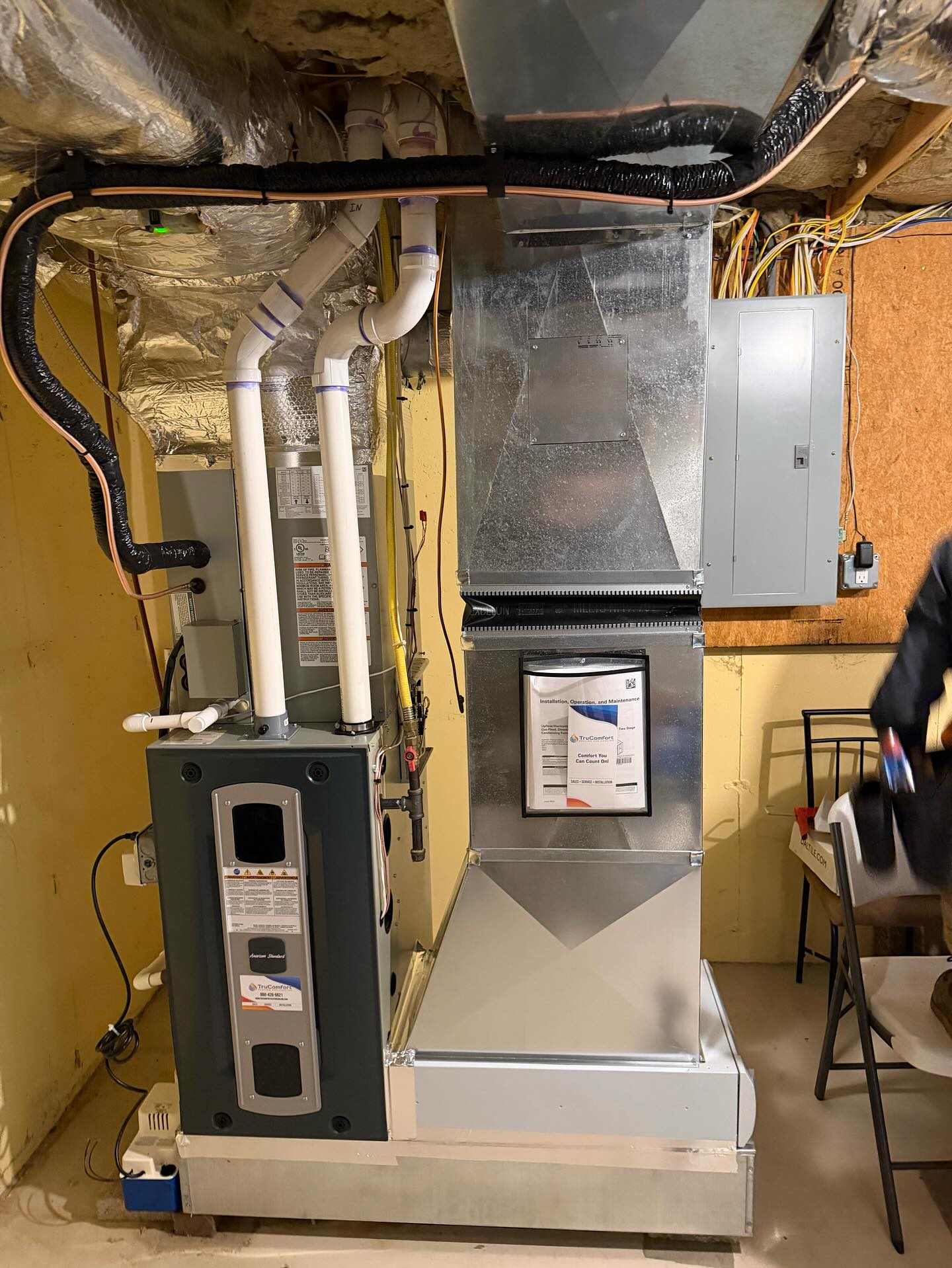 New heating system installation in a Southington Connecticut basement with ductwork and PVC vent piping.